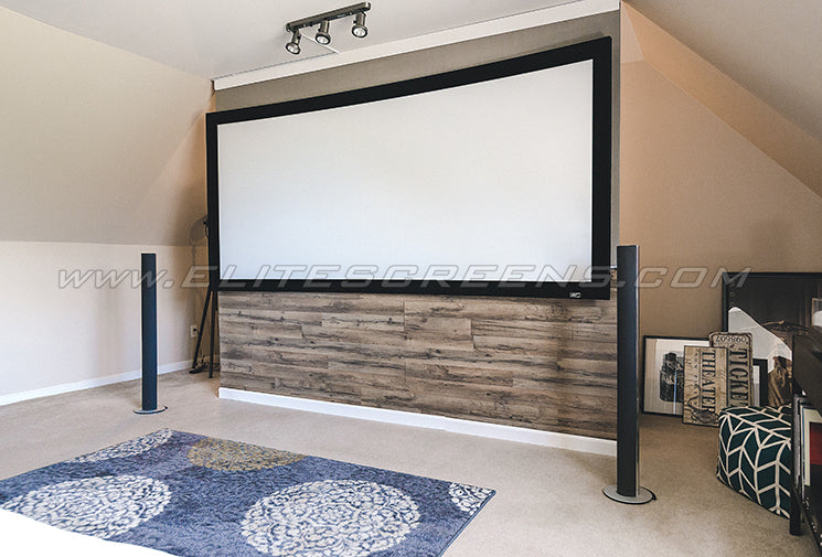 An installed Lunette 2 Series curved fixed frame projection screen by Elite Screens in a room with home theater setup.