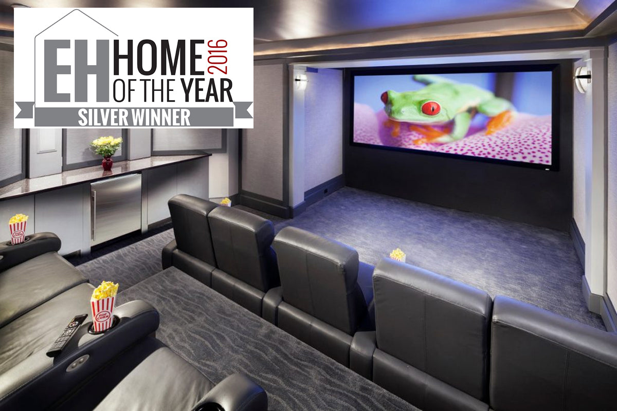 Bright Theater room with a fixed frame screen displaying a bright green frog scene with EH logo in the corner