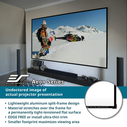 Projector screen with a snow-themed presentation in a room, featuring Elite Screens Aeon Series.