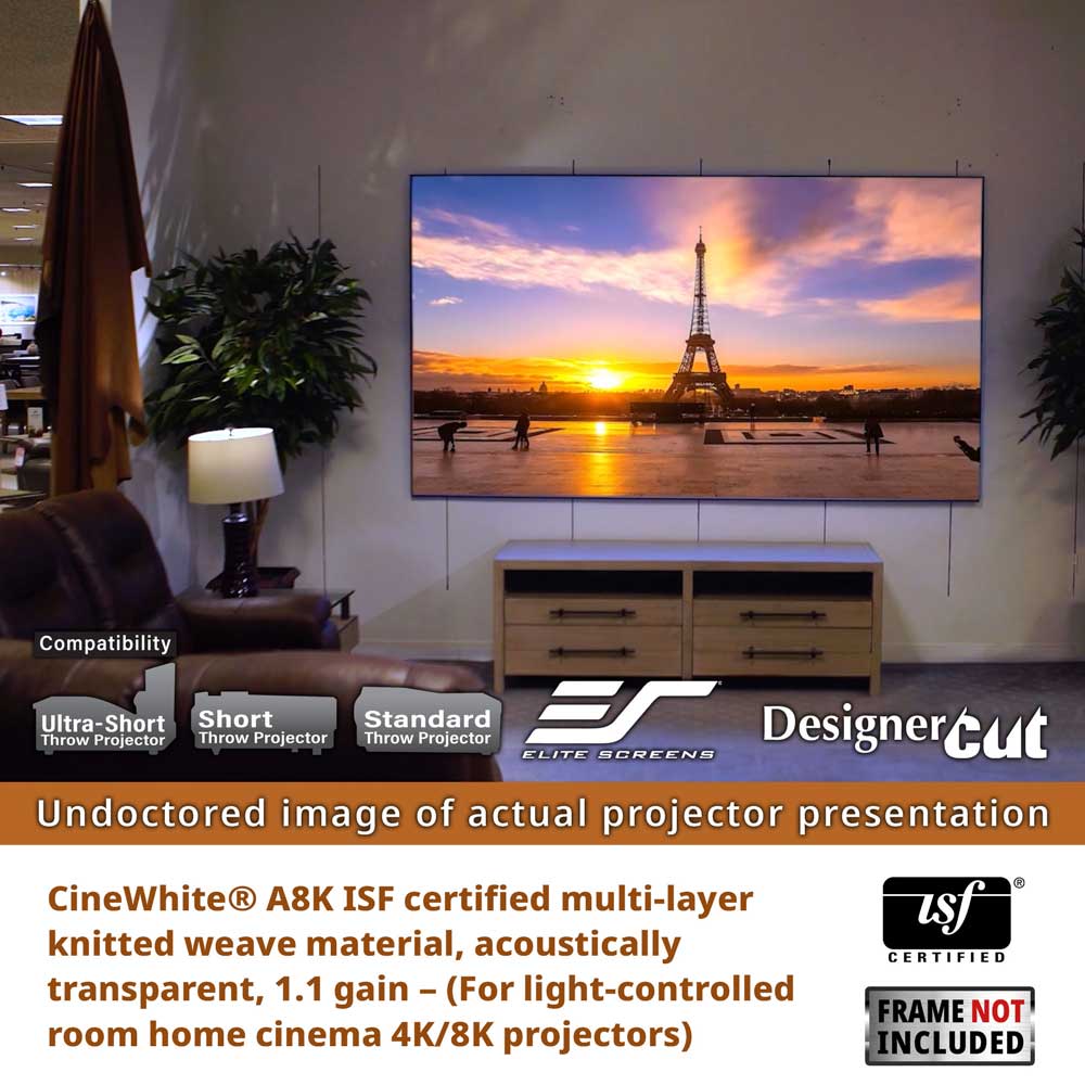 A large wall-mounted projector screen displays a sunset scene with the Eiffel Tower, shown in a home cinema setting above a wooden media console. The image includes compatibility callouts, a CineWhite A8K ISF certification badge, a DesignerCut logo, and a frame not included notice.