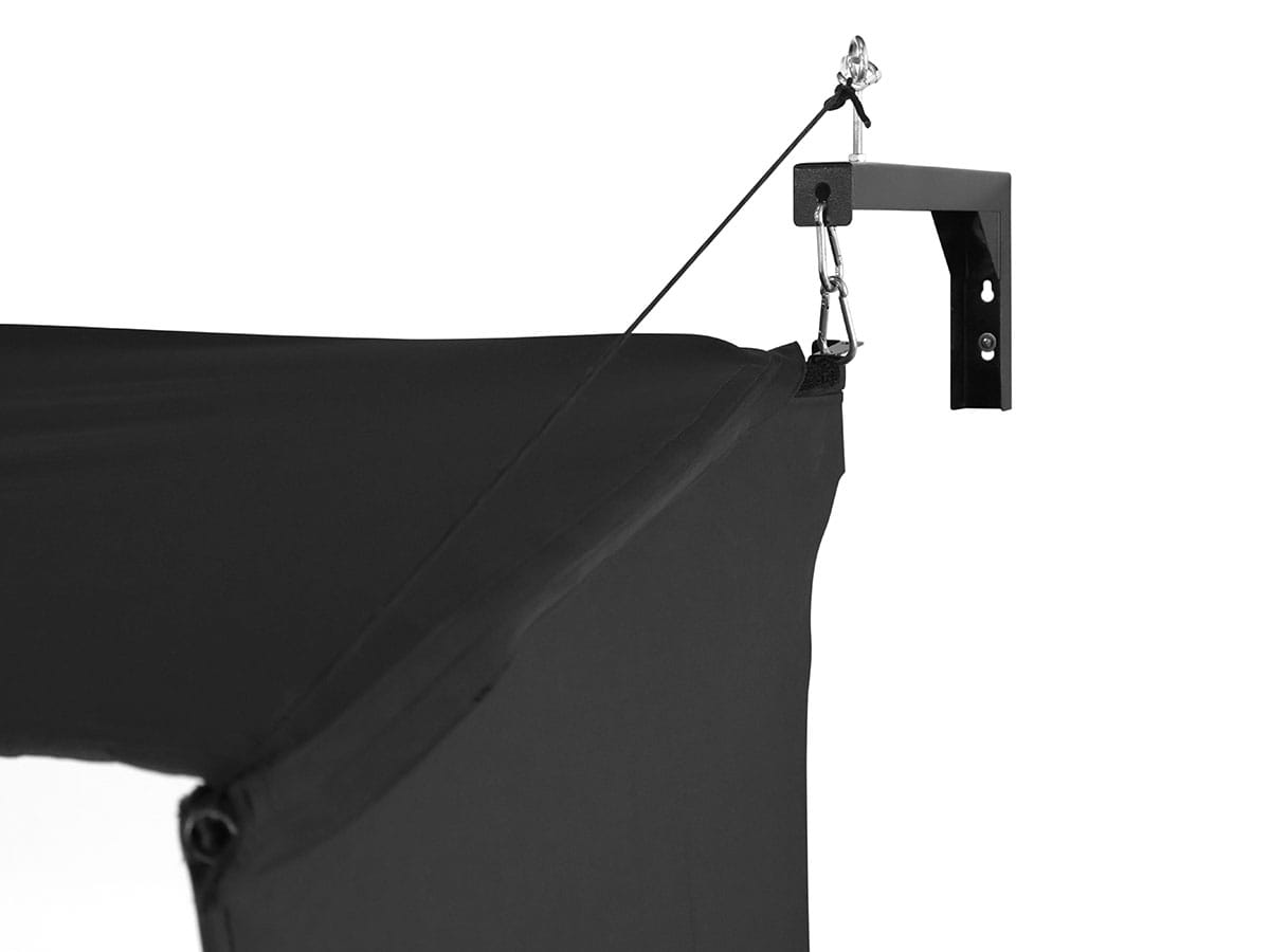 Black photography studio backdrop with a stand on a white background