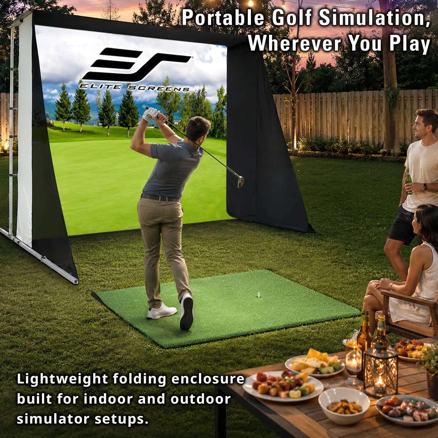 A portable golf simulation enclosure set up on a backyard lawn, with a man mid-swing inside the screen while two others watch from outside. The enclosure has a large golf course view, black side panels, and a green hitting mat.