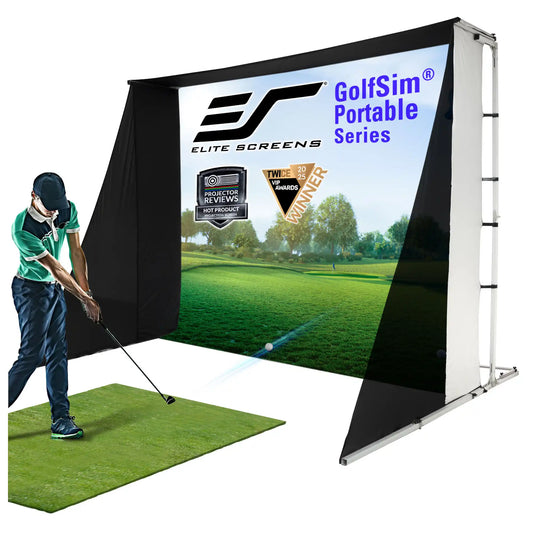 A golf simulator setup with a large printed screen showing a golf course, a black side curtain, a white support frame, and a green turf mat. A person in a green shirt is shown hitting a golf ball on the mat.