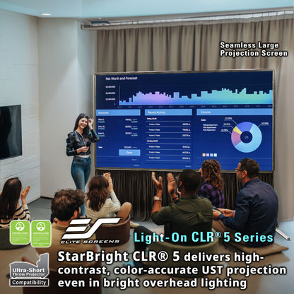 Woman presenting in front of a large projection screen with audience, Elite Screens branding visible.