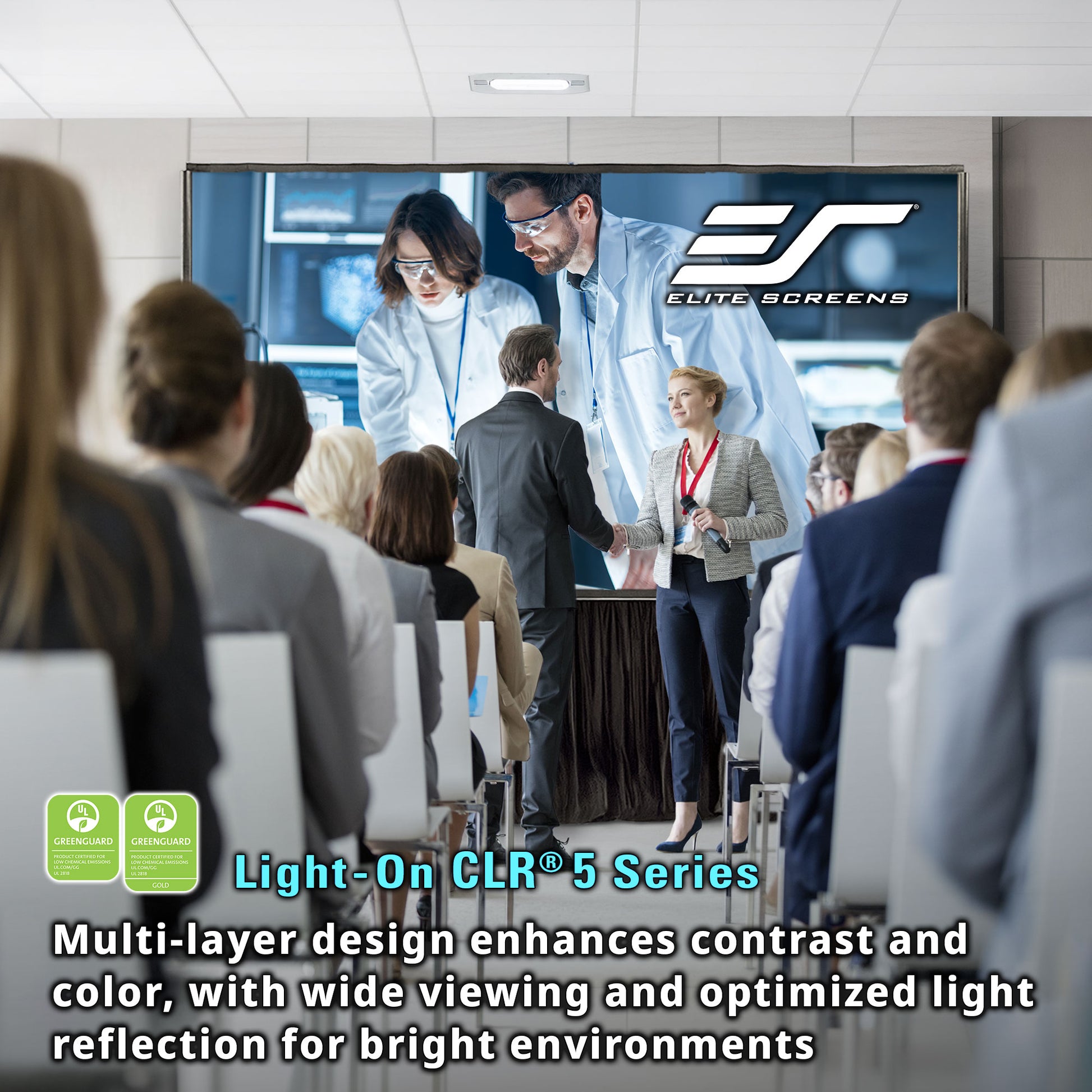 People in a conference room watching a presentation on an Elite Screens display.