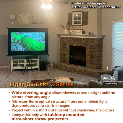 Living room with a projector screen displaying an image, featuring text about the Light-On CLR 3 Series projector.