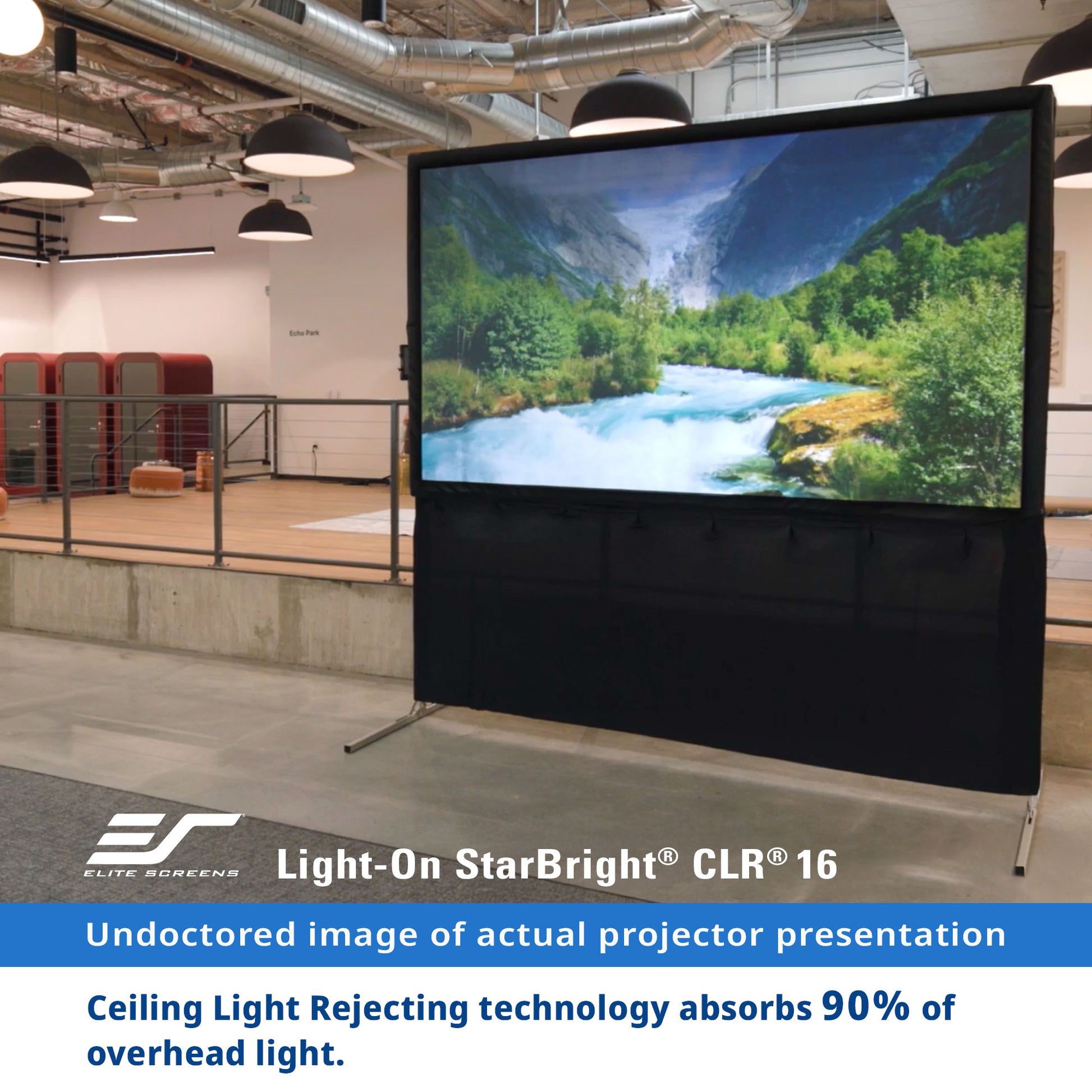 Projector screen with scenic display in a room with ceiling lights