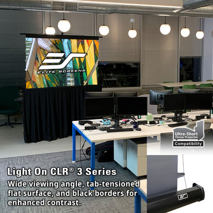 Office setting with a large screen displaying Elite Screens logo, surrounded by office furniture and equipment.