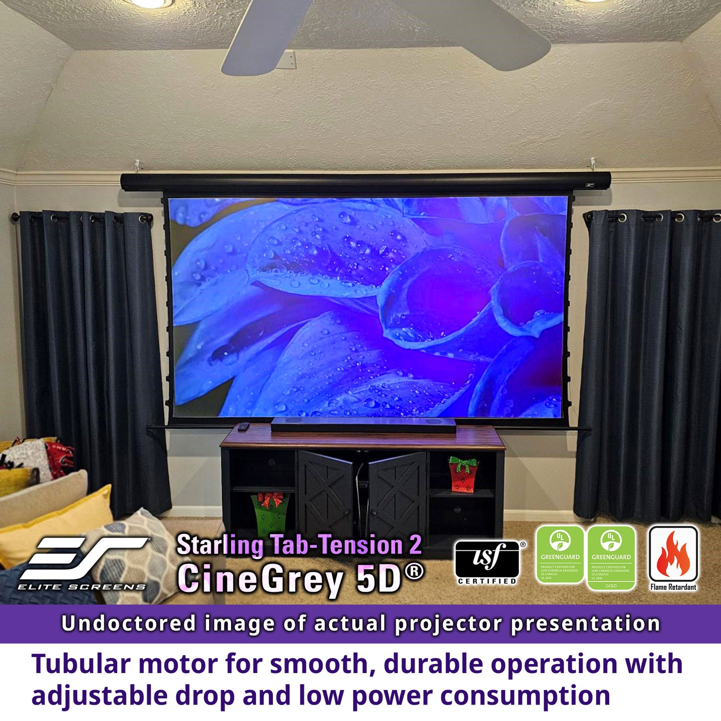 Projector screen in a room with black curtains and a TV stand.