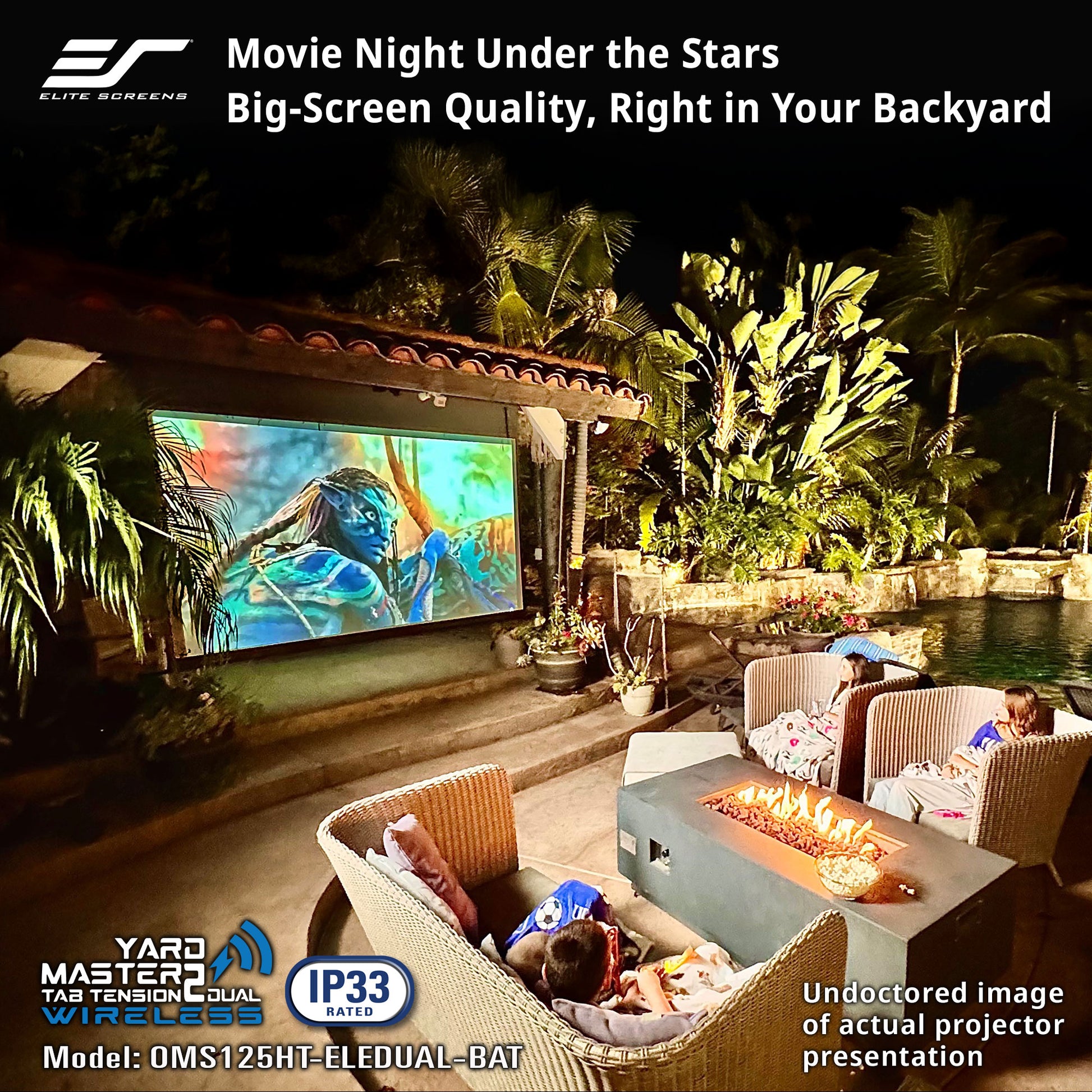 Outdoor movie night setup with a screen displaying a movie, people sitting on lounge chairs, and a fire pit.